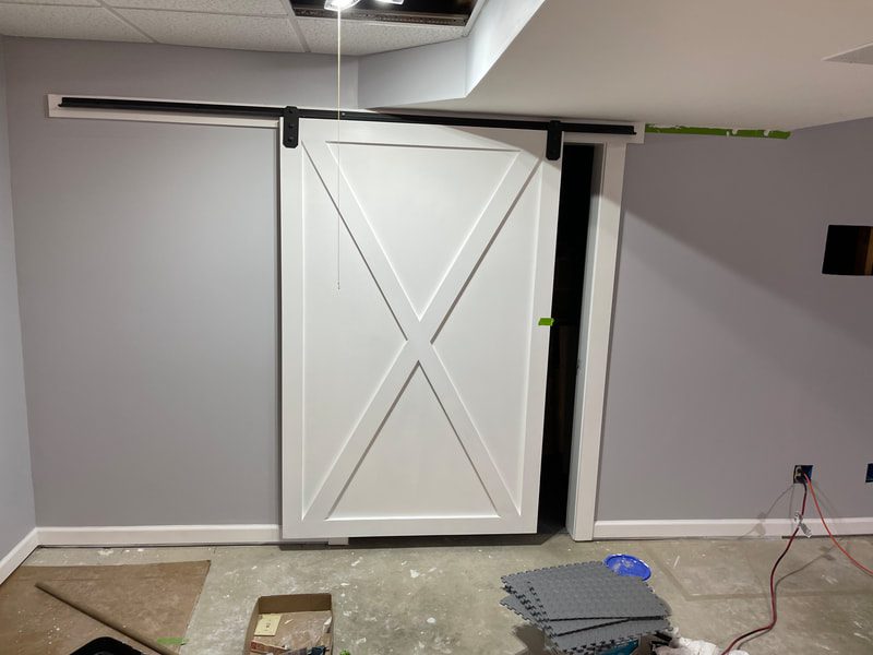 White Barn Door Against White Wall in Room