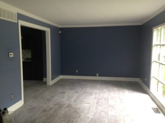 A Room With Blue Walls and Hardwood Floors