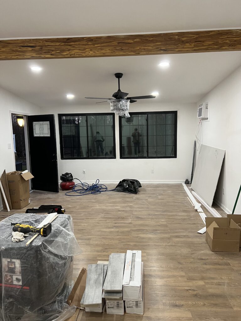 A Room With Wooden Floors and a Ceiling Fan