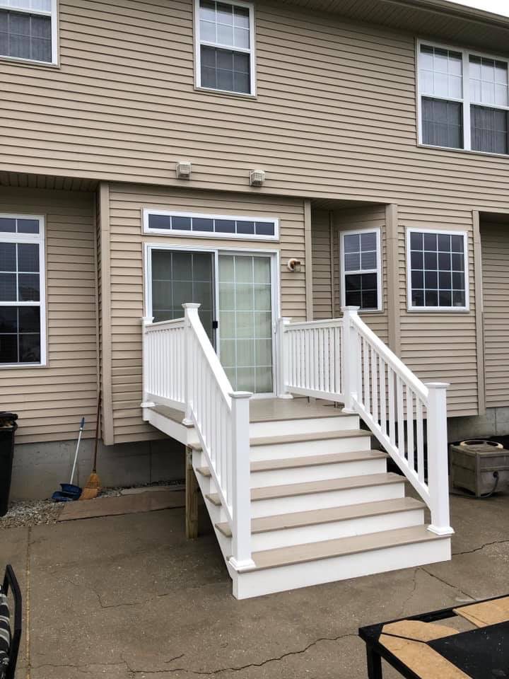 Exterior Deck With White Railing and Stairs