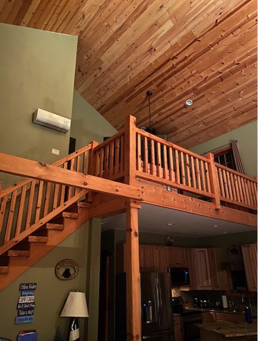 A Loft With a Staircase Leading to a Loft Bed