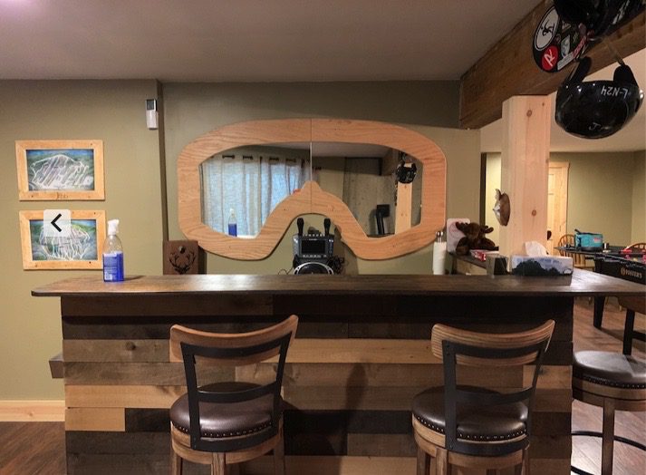 A Bar Counter With a Mirror and Ski Goggles Placed on It