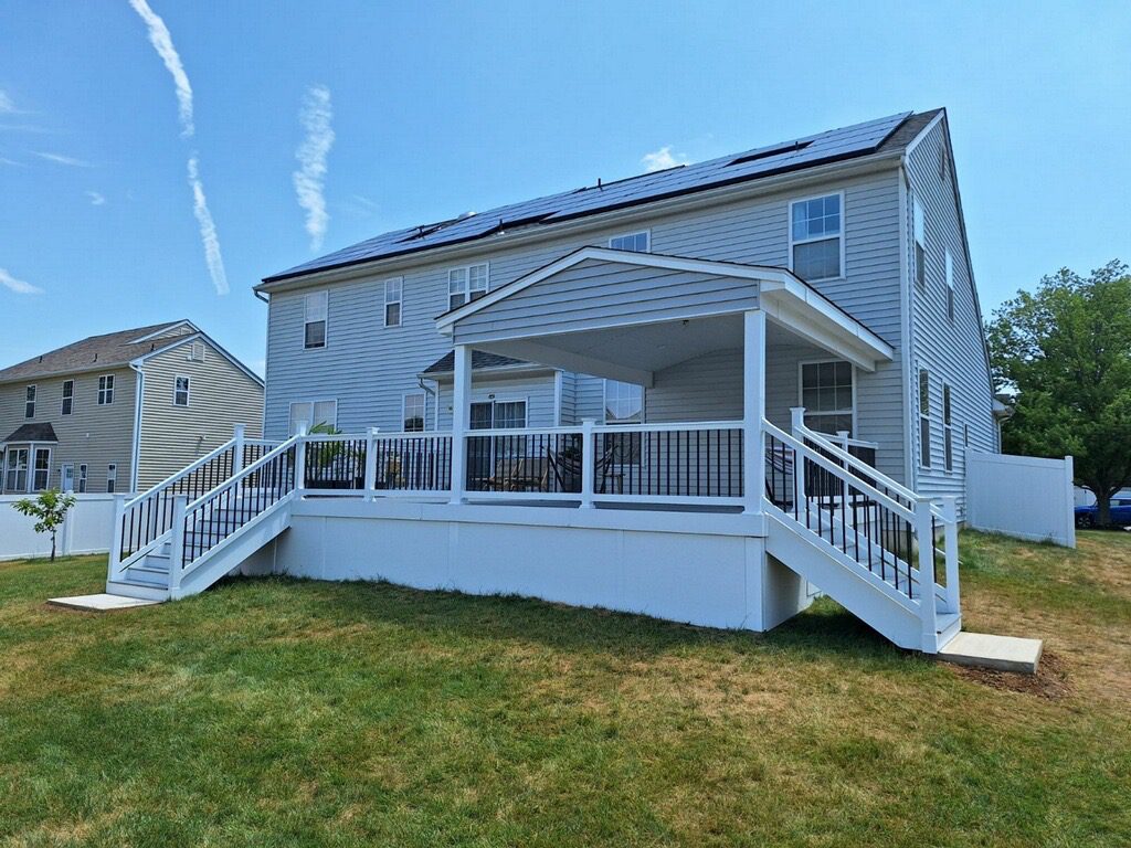 Home With a Deck and Solar Panels on the Roof