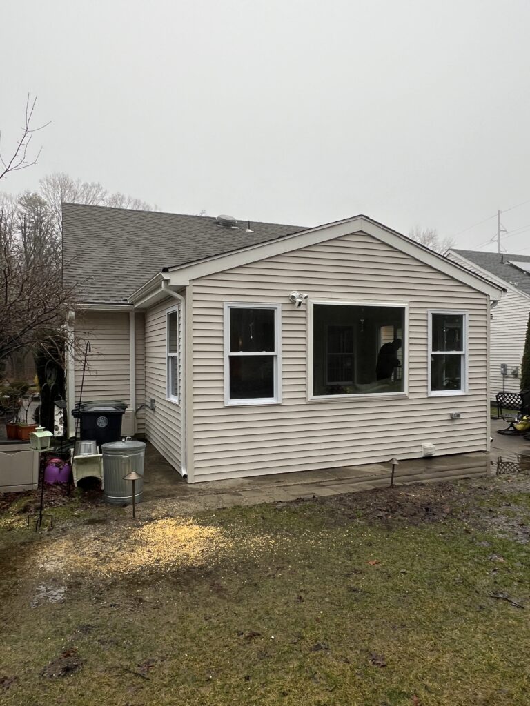 A House With a Large Window and a Small Yard