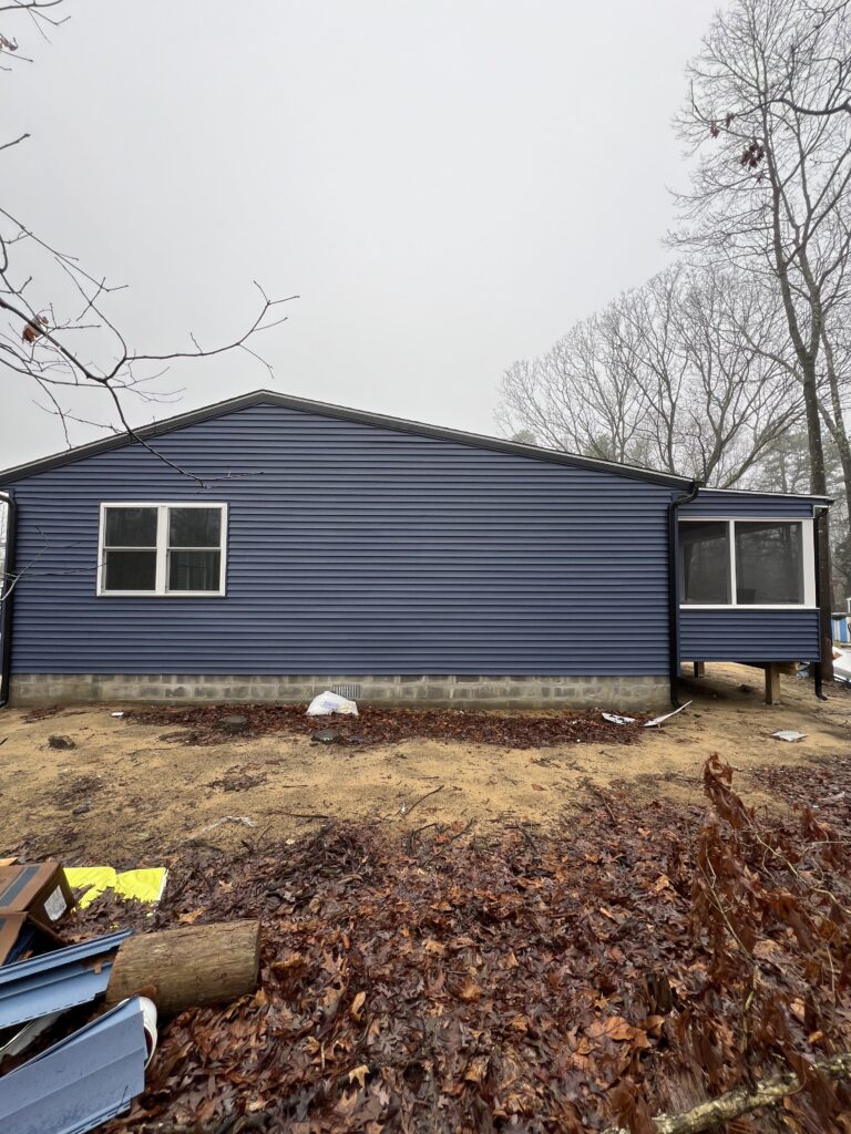 A Blue House With Matching Blue Siding and Windows
